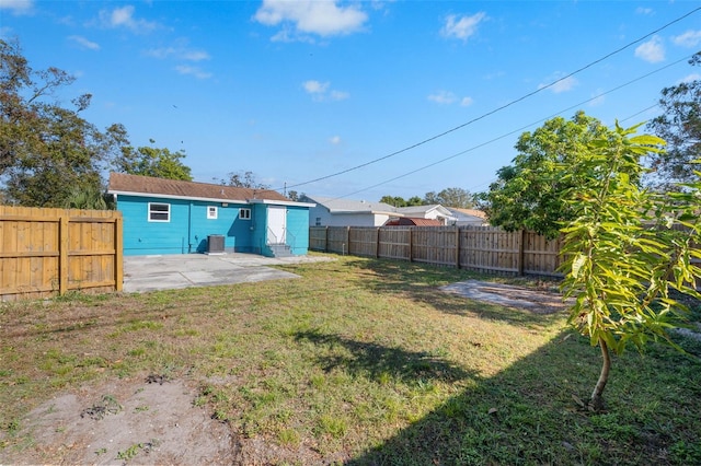 view of yard featuring cooling unit and a patio