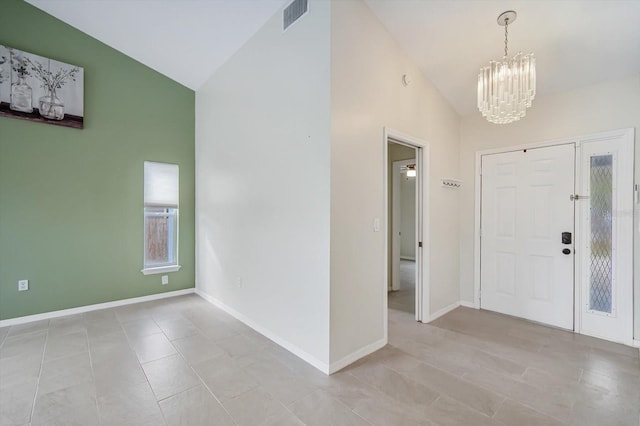 foyer featuring a chandelier and vaulted ceiling