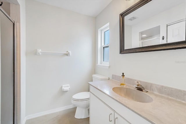 bathroom featuring tile patterned flooring, vanity, toilet, and an enclosed shower