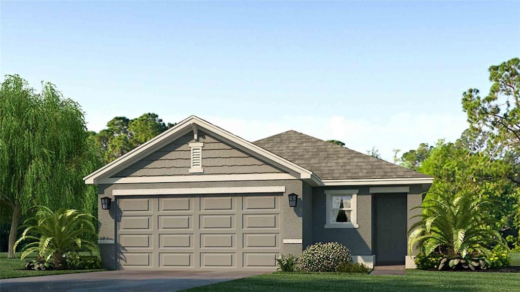 view of front of property with a garage and a front yard