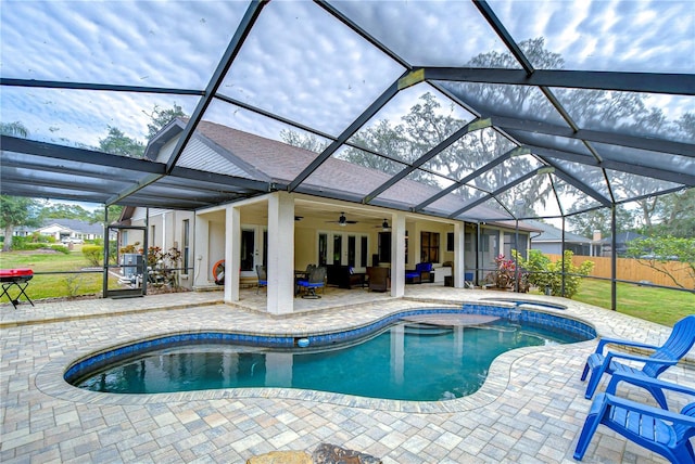 view of swimming pool featuring french doors, an outdoor hangout area, glass enclosure, and a patio