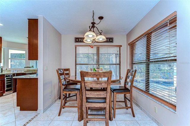 dining room with light tile patterned flooring and beverage cooler