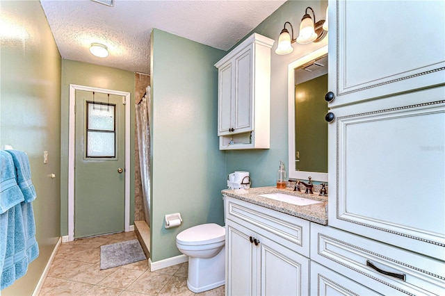 bathroom with vanity, tile patterned floors, a shower with curtain, toilet, and a textured ceiling