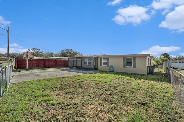 back of house featuring a yard and a patio area