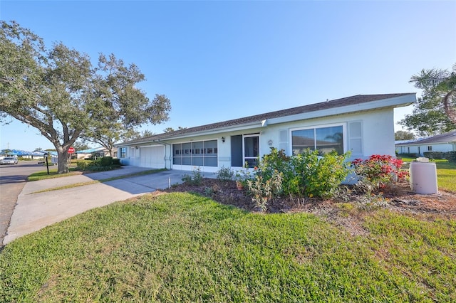 ranch-style house featuring a front lawn and a garage