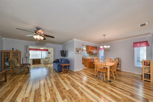 dining room with plenty of natural light, light hardwood / wood-style floors, and ornamental molding