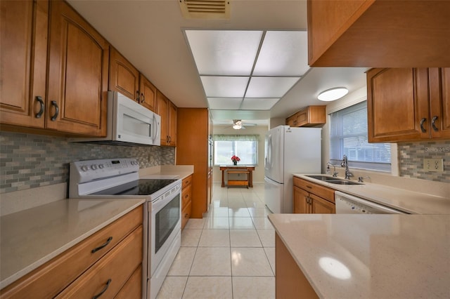 kitchen featuring decorative backsplash, ceiling fan, white appliances, and sink