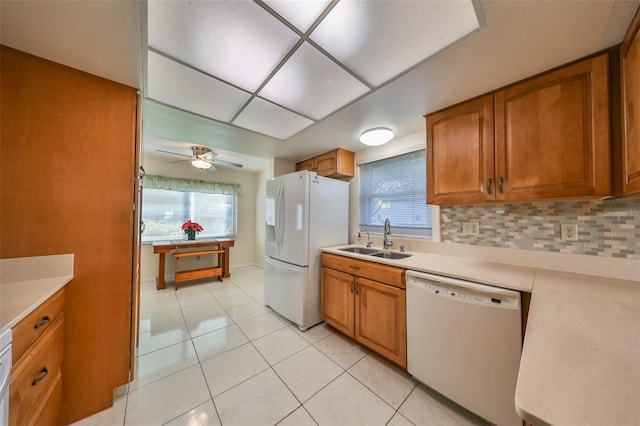 kitchen featuring tasteful backsplash, white appliances, ceiling fan, sink, and light tile patterned flooring