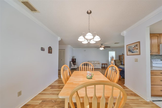 dining room featuring crown molding, ceiling fan with notable chandelier, light hardwood / wood-style floors, and a textured ceiling