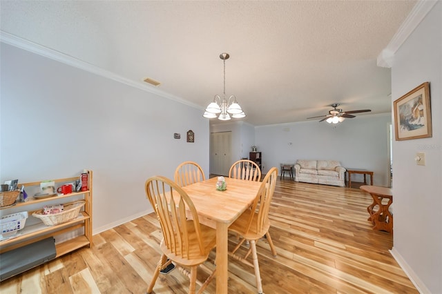 dining room featuring a textured ceiling, light hardwood / wood-style floors, ceiling fan with notable chandelier, and ornamental molding