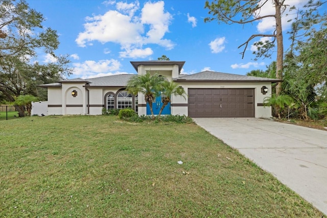 view of front of property with a garage and a front lawn