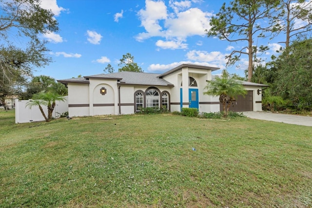 view of front of house featuring a garage and a front lawn