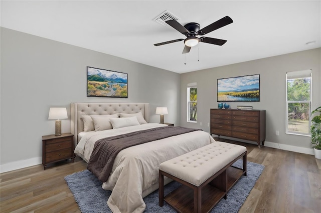 bedroom with hardwood / wood-style floors and ceiling fan