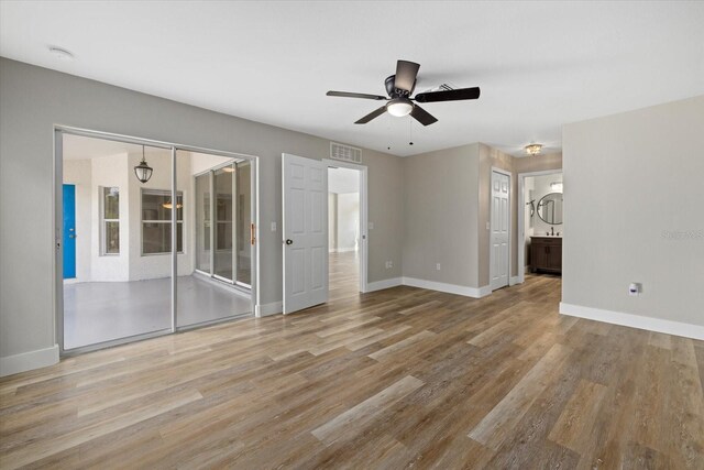 empty room featuring light wood-type flooring and ceiling fan