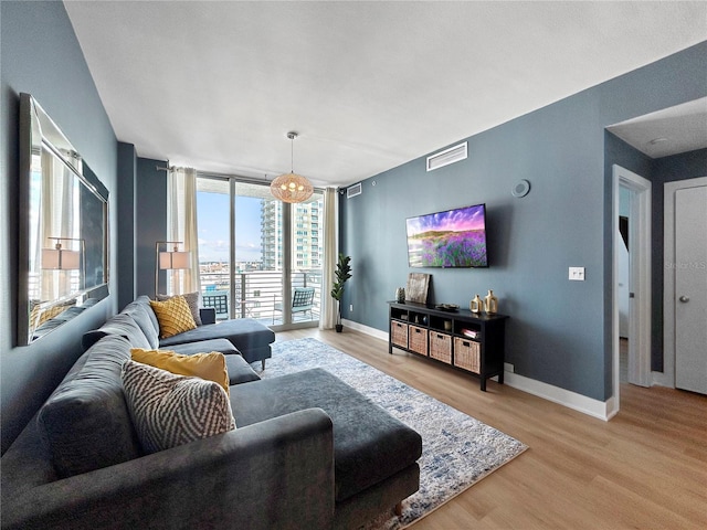 living room featuring expansive windows and light wood-type flooring