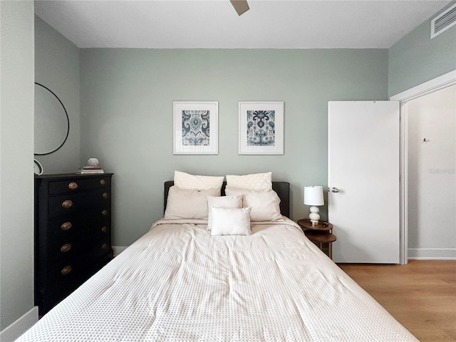 bedroom featuring ceiling fan and light hardwood / wood-style flooring