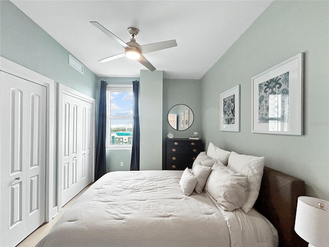 bedroom featuring multiple closets and ceiling fan