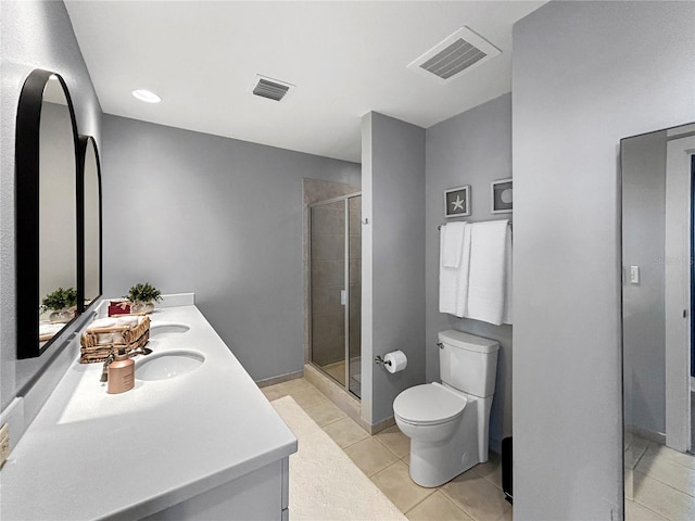 bathroom with toilet, vanity, tile patterned floors, and an enclosed shower