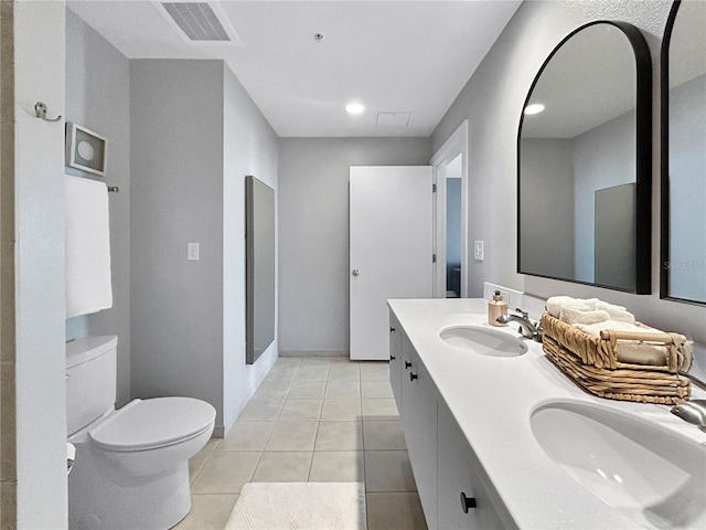 bathroom featuring tile patterned flooring, vanity, and toilet