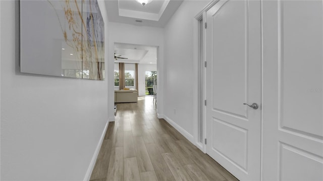 corridor with light hardwood / wood-style floors