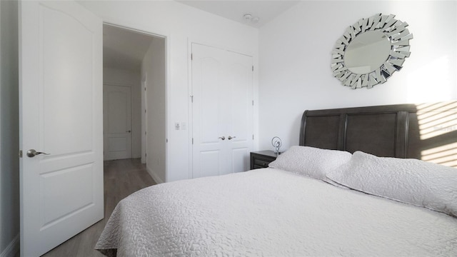 bedroom with dark hardwood / wood-style floors