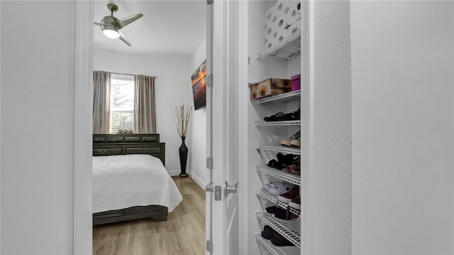 bedroom with light hardwood / wood-style floors and ceiling fan