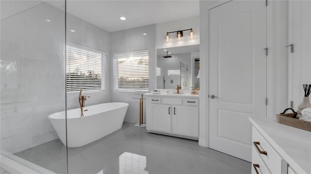 bathroom featuring vanity and independent shower and bath