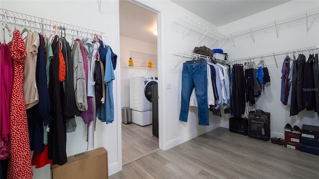 spacious closet with washer / clothes dryer and hardwood / wood-style flooring