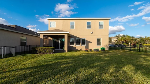 rear view of house with a lawn