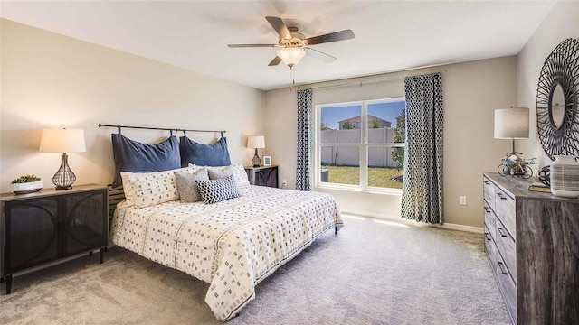 bedroom with ceiling fan and light carpet