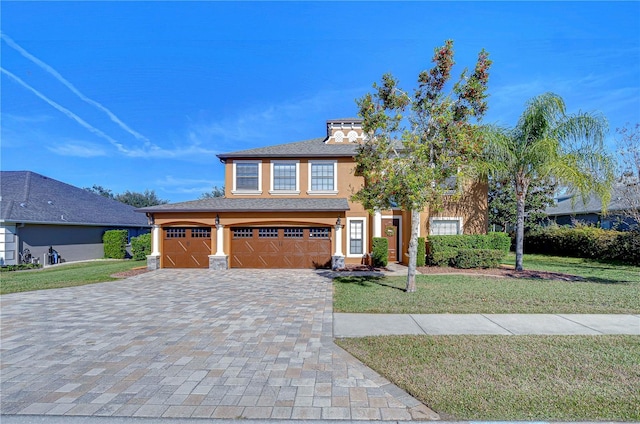 view of front facade with a garage and a front yard