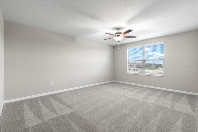 carpeted spare room with ceiling fan and a textured ceiling