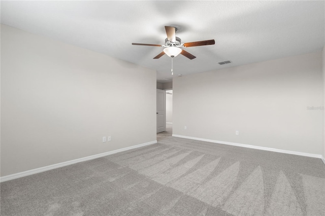 spare room featuring ceiling fan and light colored carpet