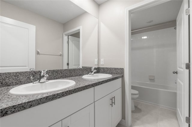 full bathroom with vanity, tile patterned floors, tiled shower / bath combo, and toilet