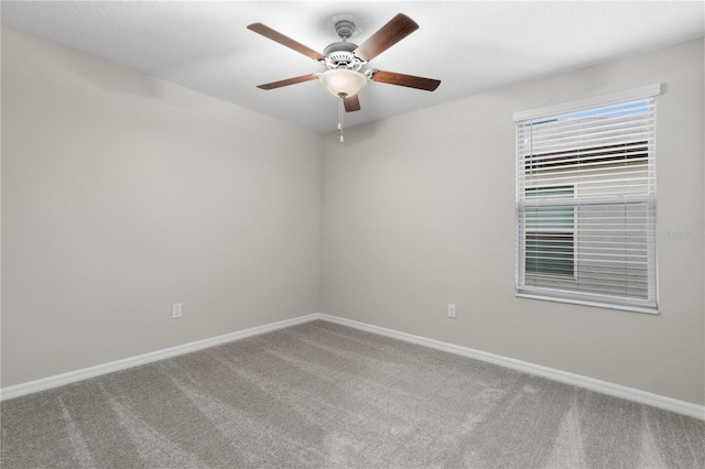 carpeted empty room featuring ceiling fan