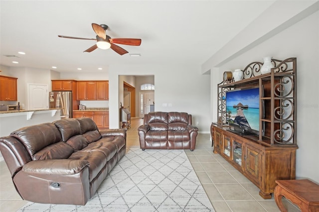 tiled living room with ceiling fan