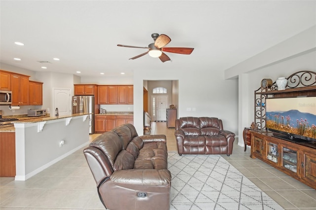 tiled living room featuring ceiling fan