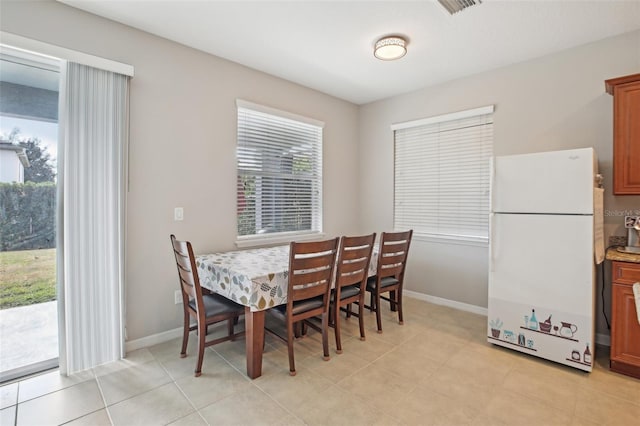 dining area featuring light tile patterned floors