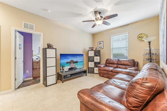 living room featuring ceiling fan and light tile patterned flooring