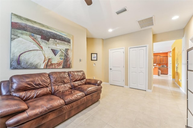 tiled living room featuring ceiling fan