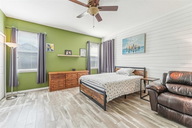 bedroom featuring light hardwood / wood-style flooring and ceiling fan