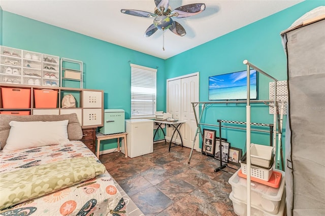 bedroom featuring a closet, fridge, and ceiling fan