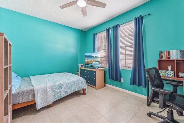 tiled bedroom with ceiling fan and a textured ceiling