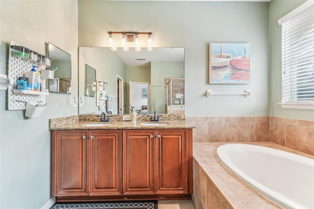 bathroom featuring vanity and independent shower and bath