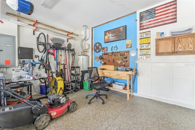 garage with a workshop area and electric panel