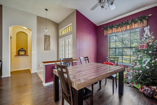 dining space featuring french doors, vaulted ceiling, ceiling fan, and dark wood-type flooring