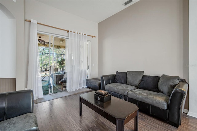 living room with wood-type flooring and ceiling fan