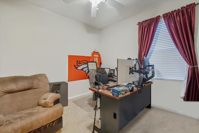 office space featuring light carpet and ceiling fan