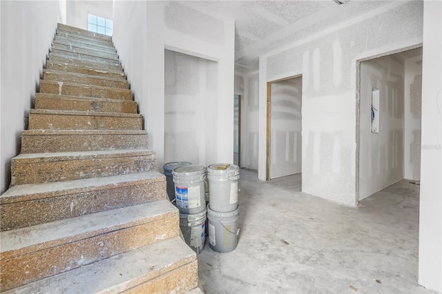 stairs featuring concrete floors