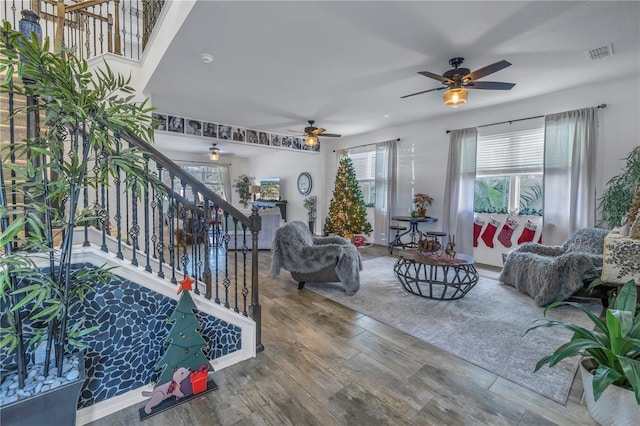 living room featuring hardwood / wood-style floors and ceiling fan